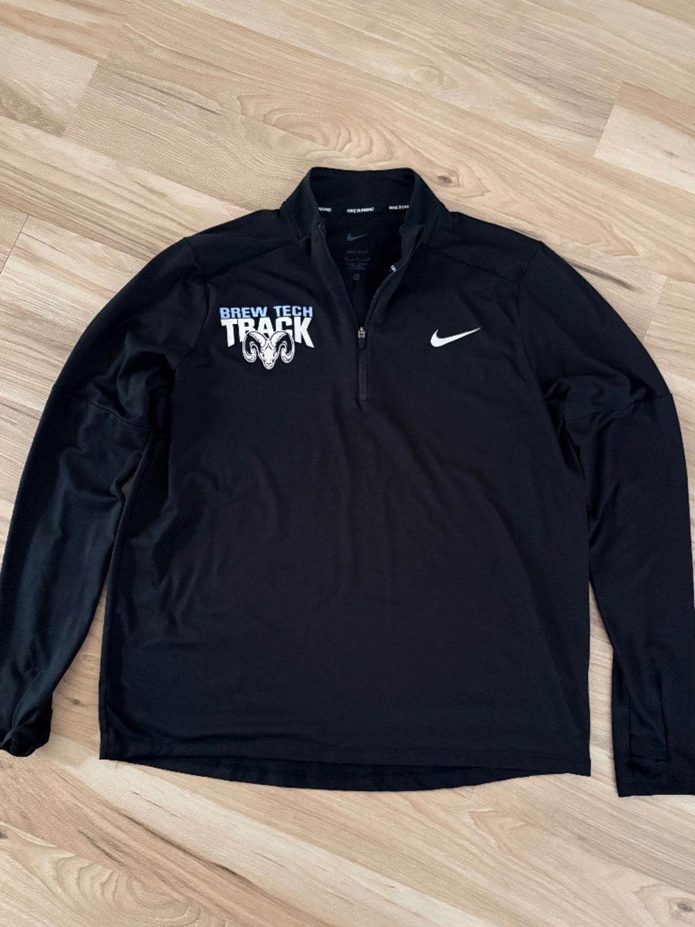 This black Nike Dri-Fit pullover features embroidered "Brew Tech Track.